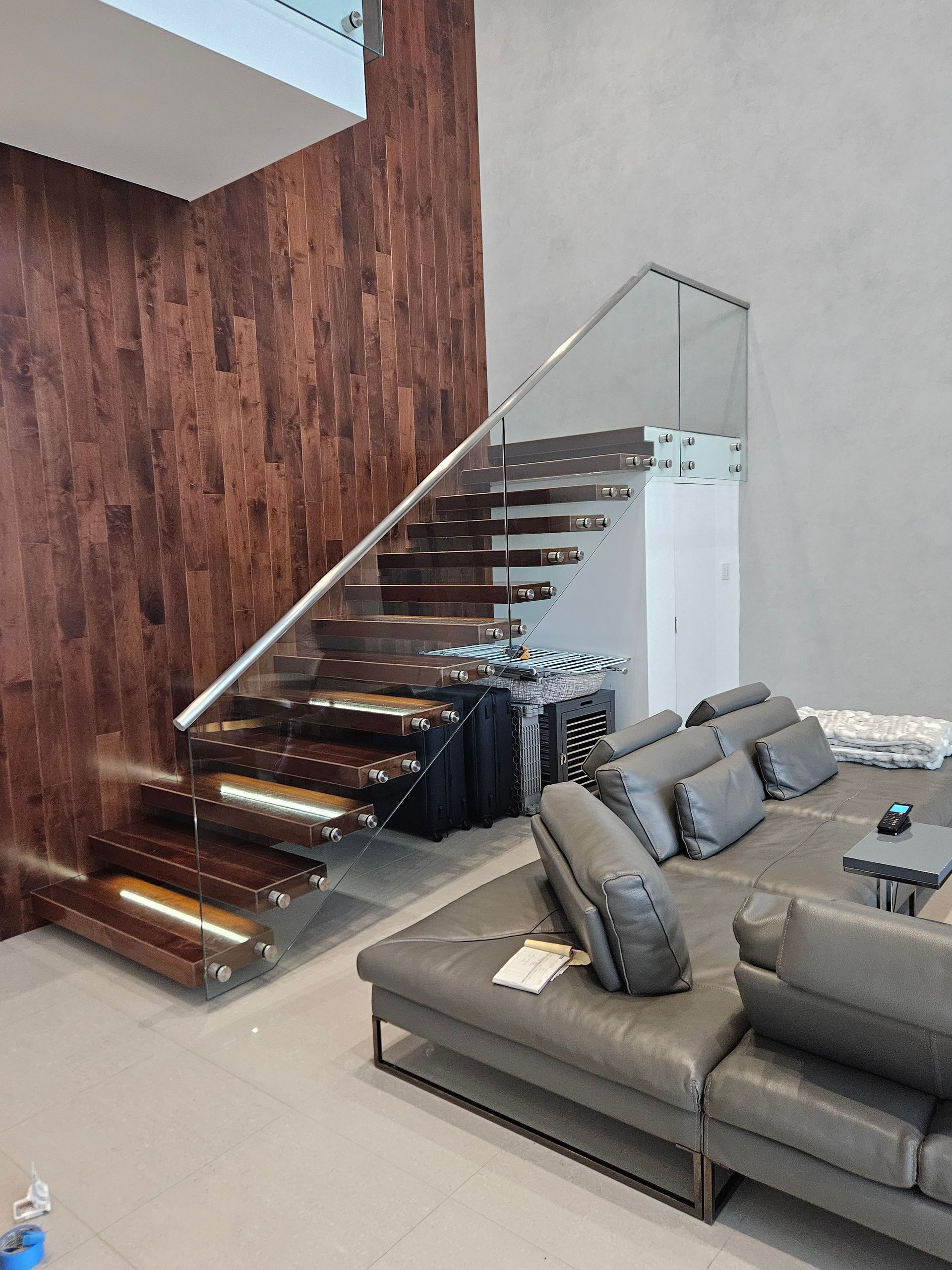 A living room with a staircase and a couch