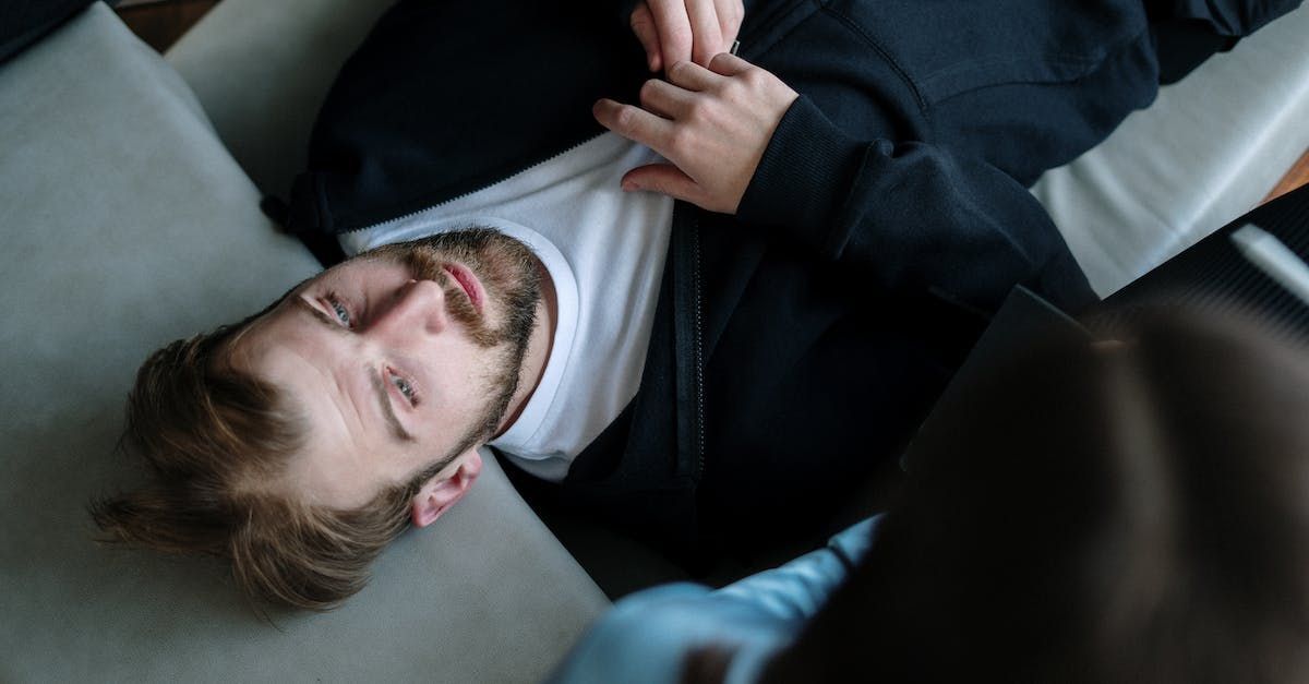 man with mental health problems laying on a couch