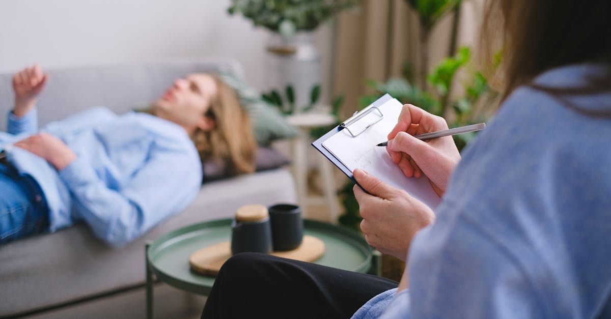 man laying on a couch at a mental health office