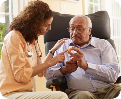 A woman is talking to an older man who is sitting in a chair