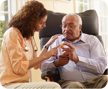 A woman is talking to an older man who is sitting in a chair