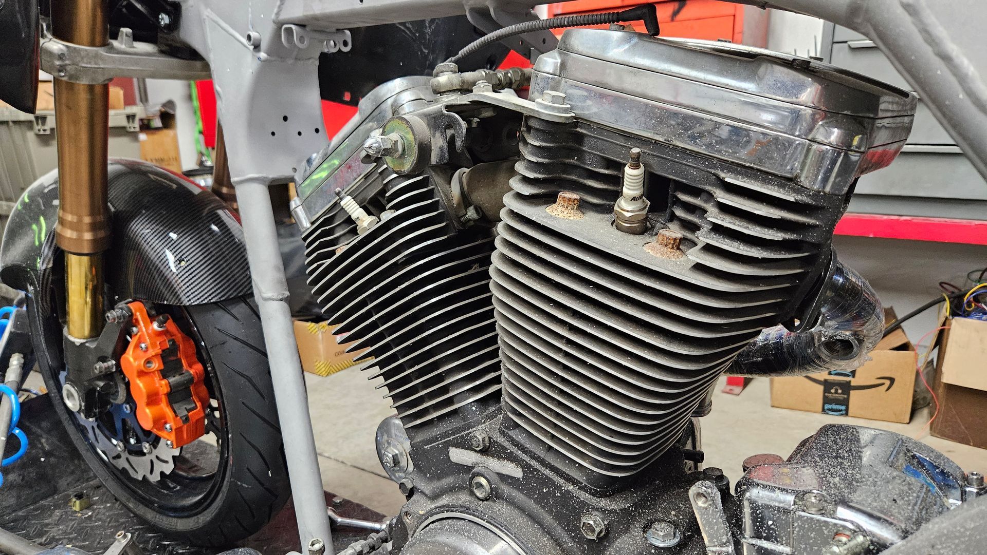 A close up of a motorcycle engine in a garage.