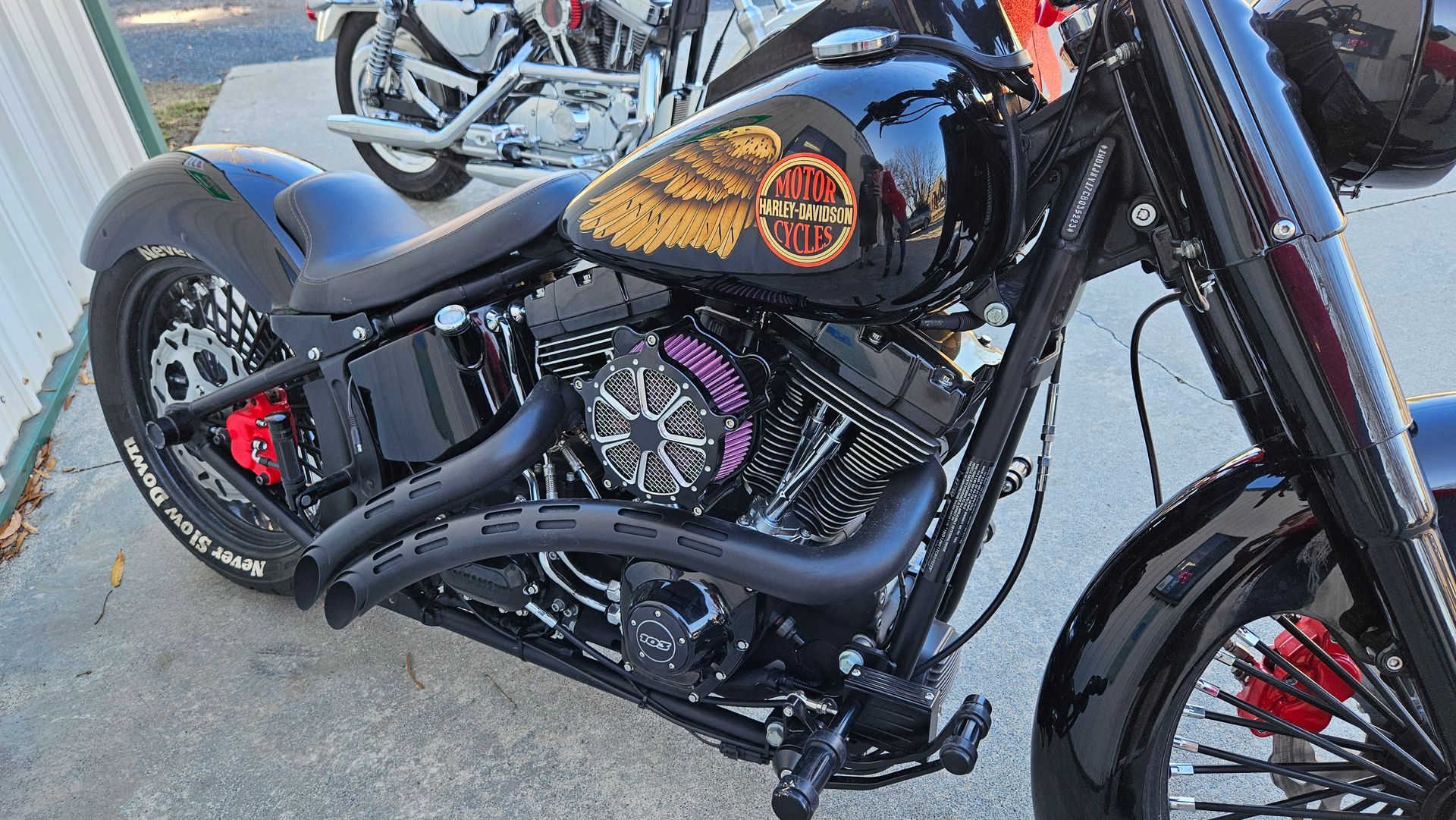 A black motorcycle is parked on the side of the road.