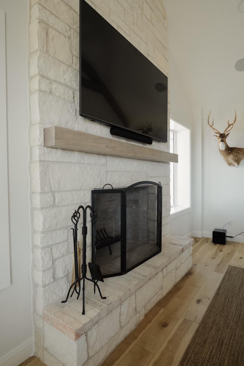 A living room with a fireplace and a flat screen tv.
