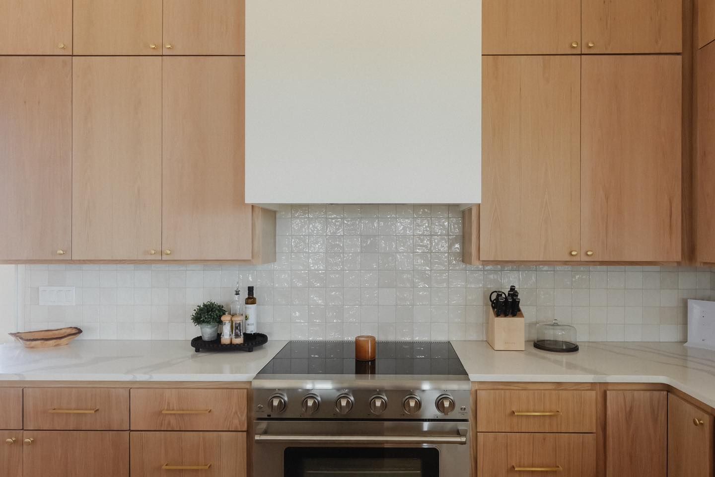 A kitchen with stainless steel appliances and wooden cabinets.