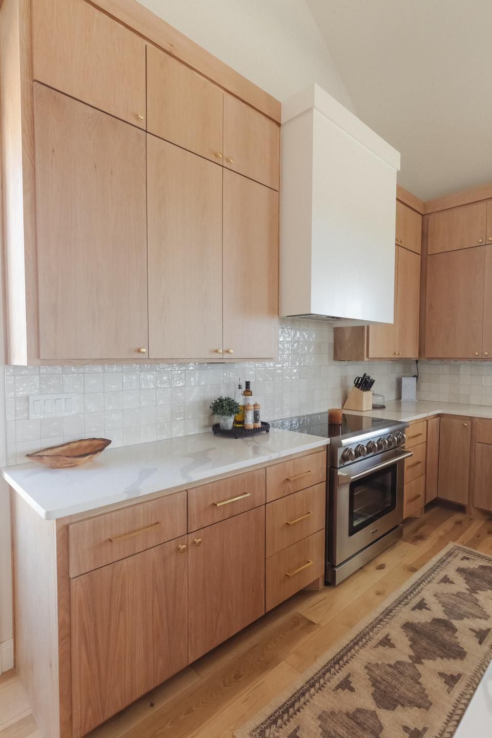 A kitchen with wooden cabinets and stainless steel appliances
