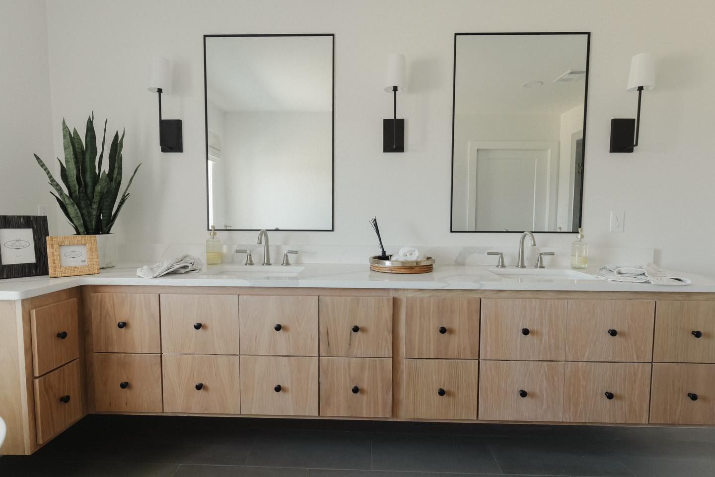 A bathroom with two sinks and two mirrors.