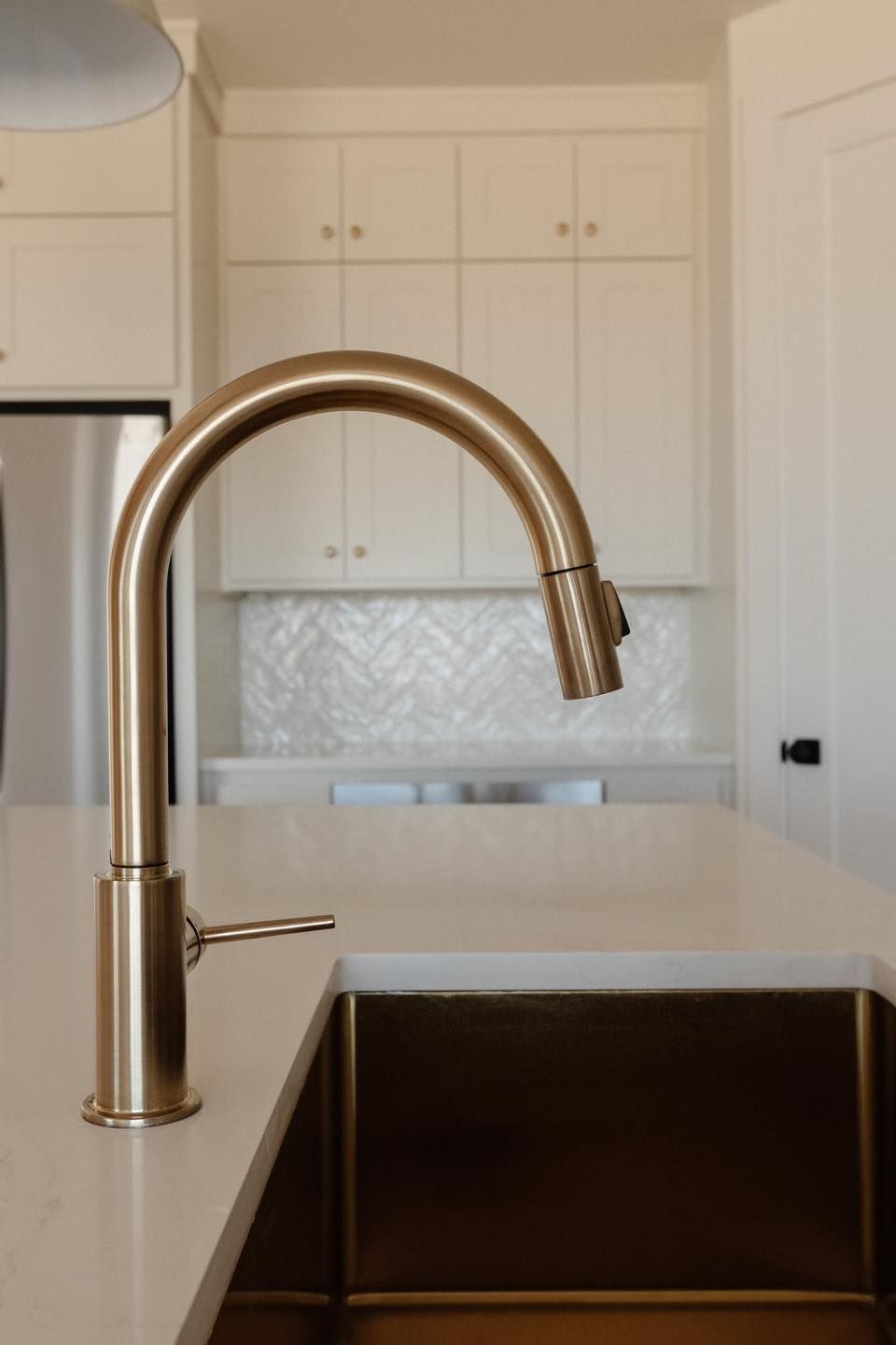A kitchen with a sink and a faucet on the counter.