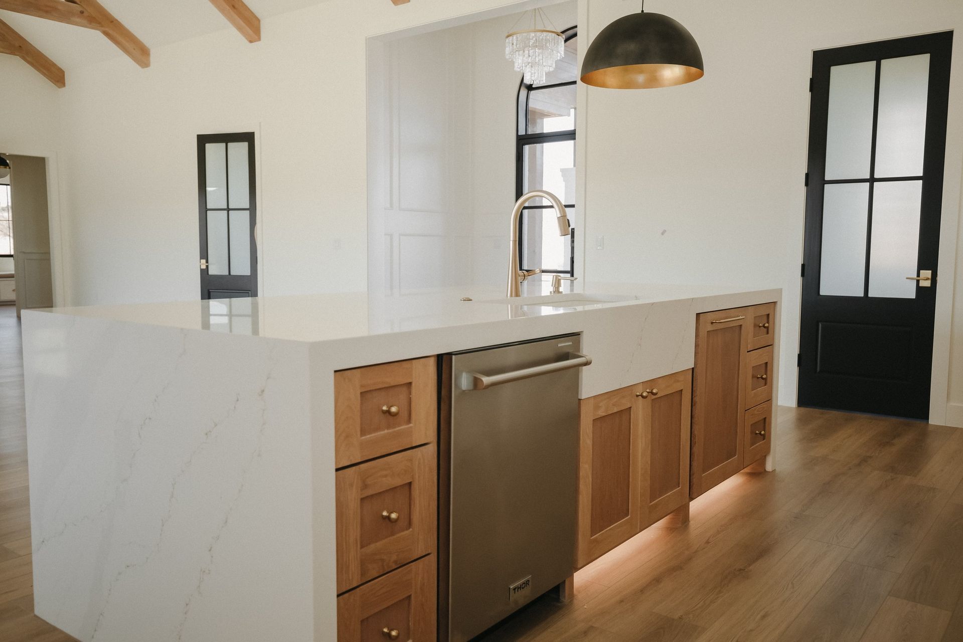 A kitchen with a large island and stainless steel appliances