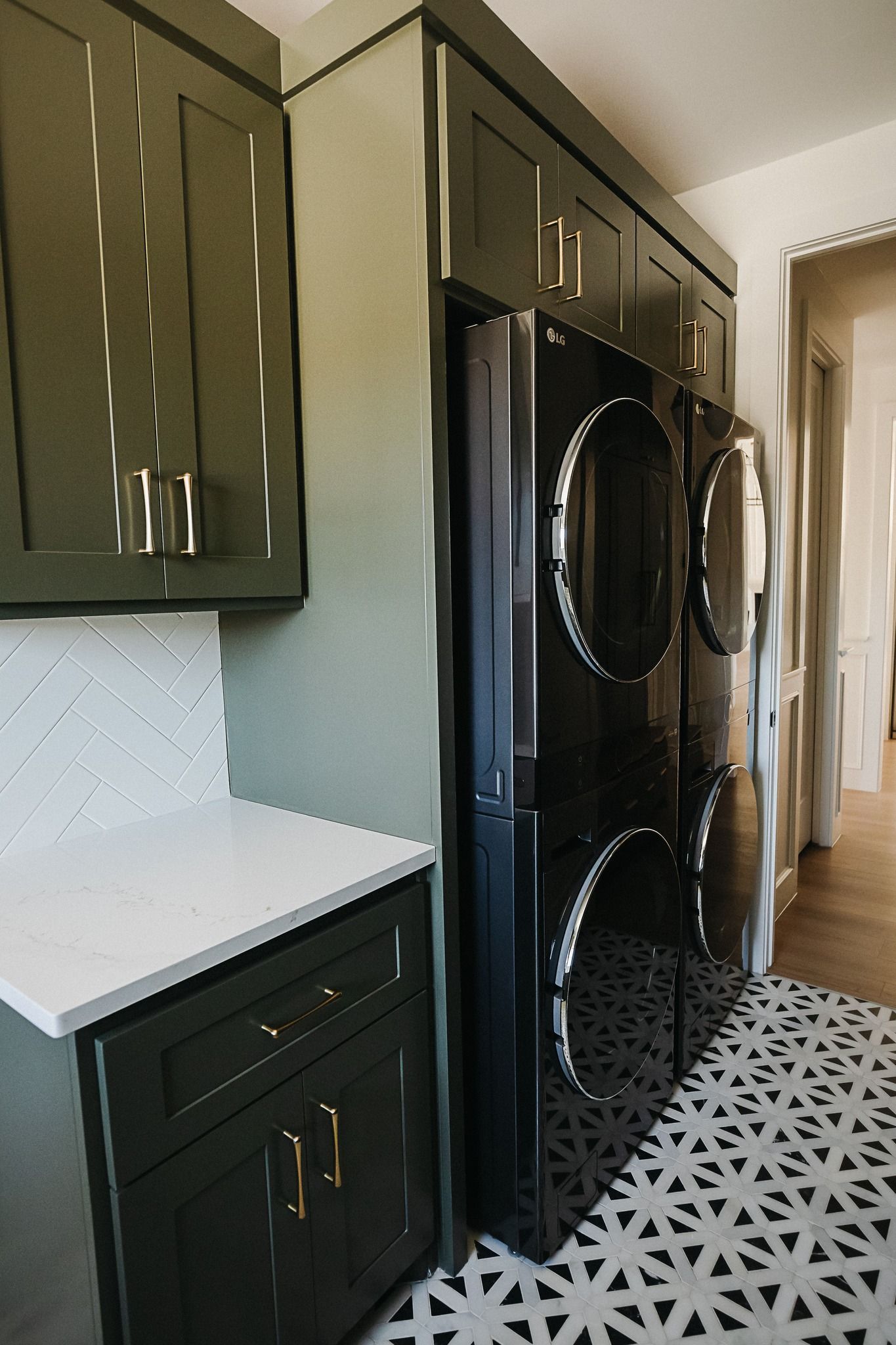 A laundry room with a washer and dryer stacked on top of each other.