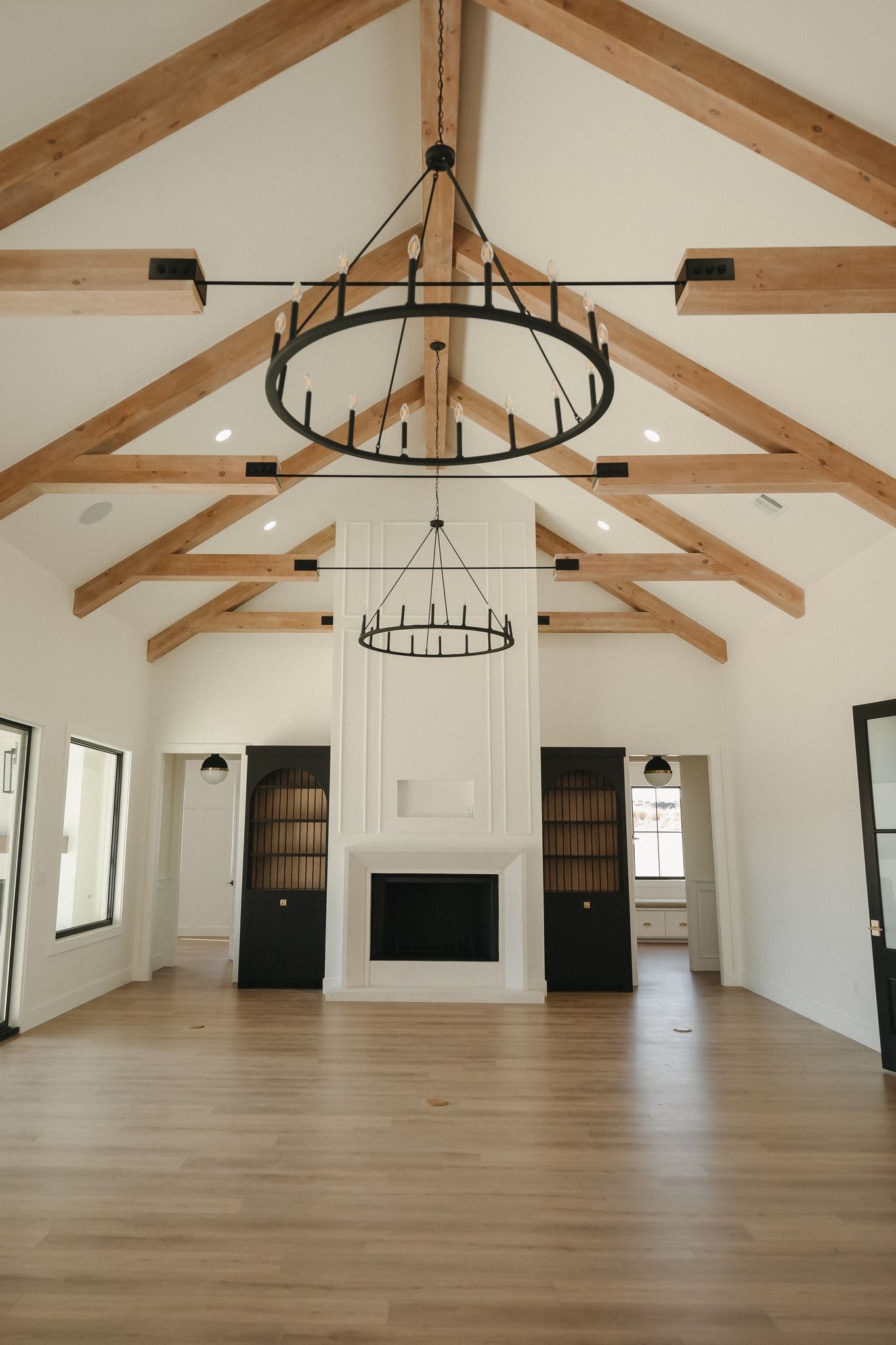 A living room with a fireplace and a chandelier hanging from the ceiling.