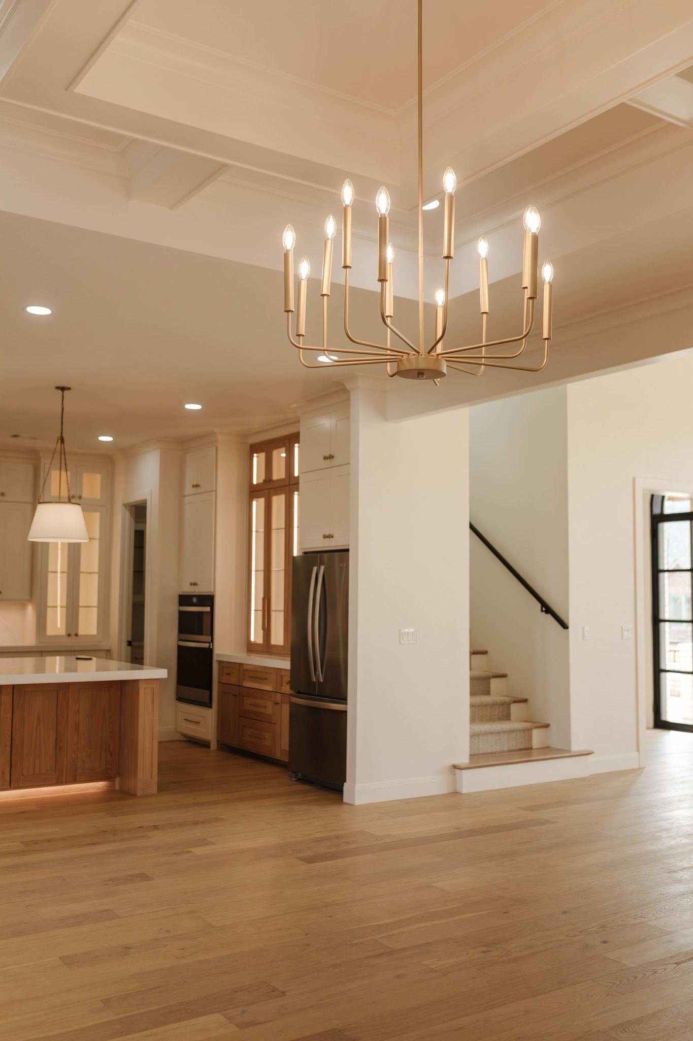 A kitchen with a chandelier hanging from the ceiling
