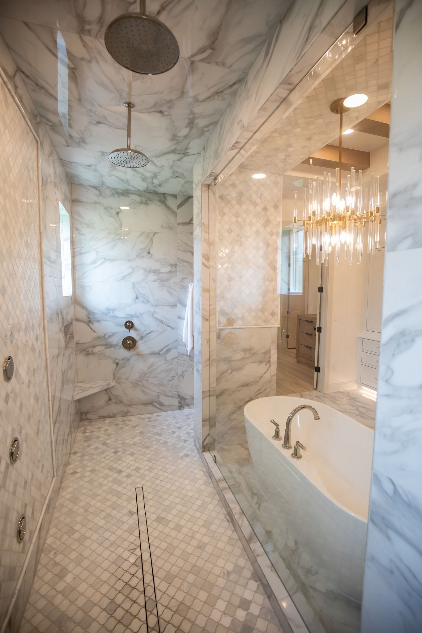 A bathroom with a tub , shower , and mirror.