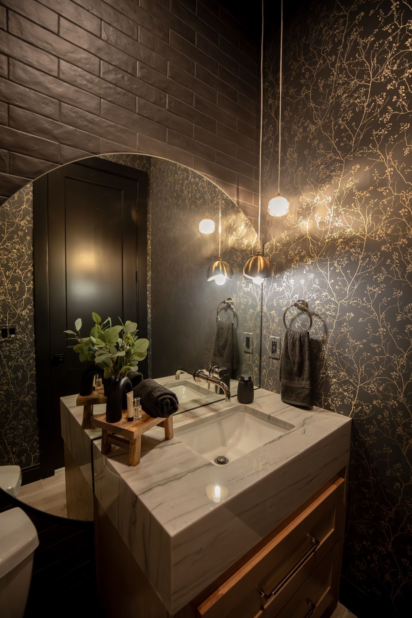 A bathroom with a sink , mirror and toilet.