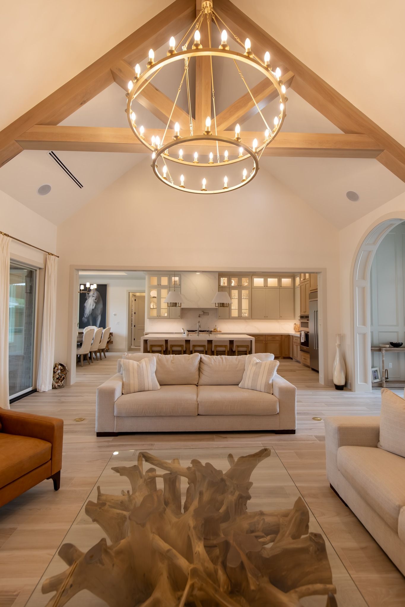 A living room with a couch and a chandelier hanging from the ceiling.