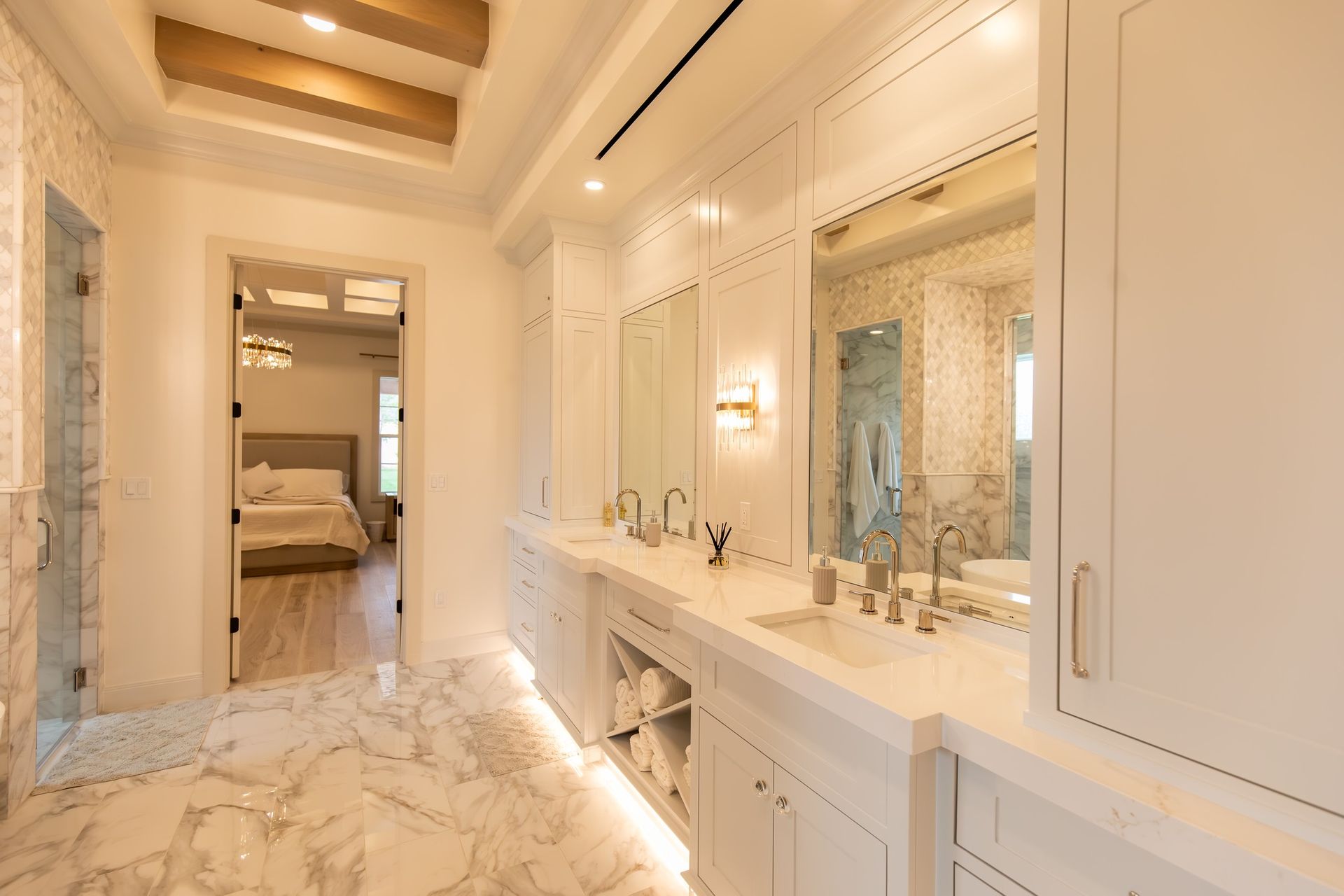 A bathroom with two sinks , two mirrors and a walk in shower.