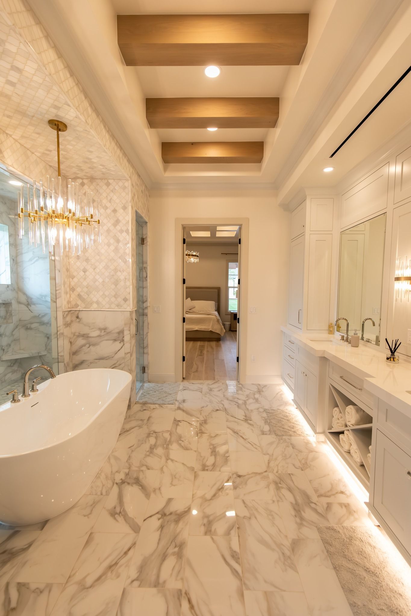 A bathroom with a bathtub , sinks , mirrors and marble floors.