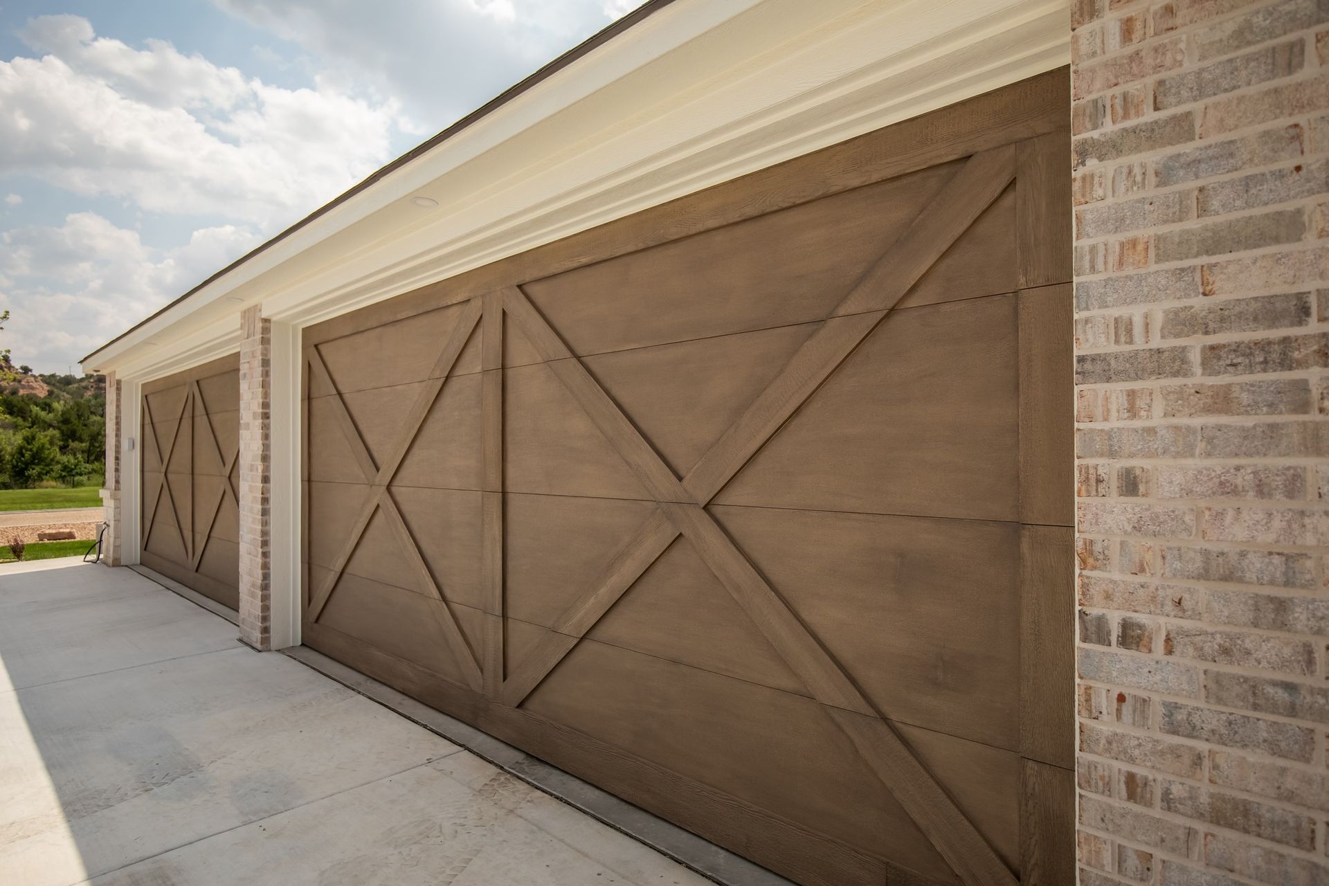 A row of garage doors on a brick building.