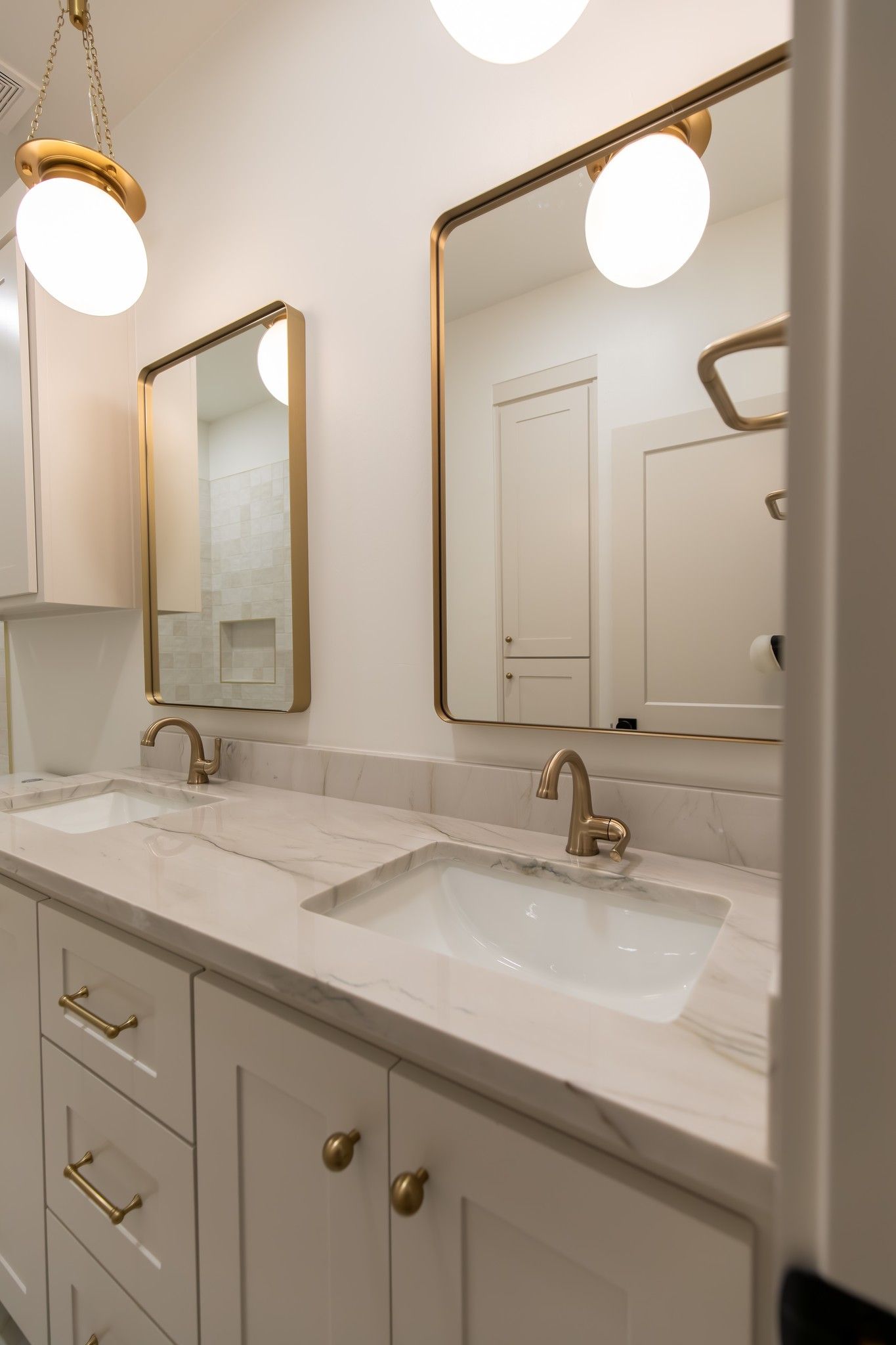 A bathroom with two sinks and two mirrors.