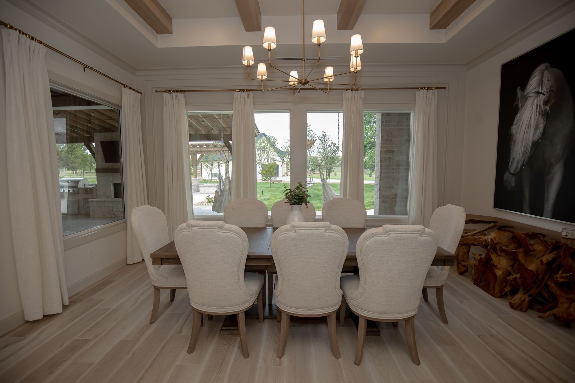 A dining room with a table and chairs and a chandelier