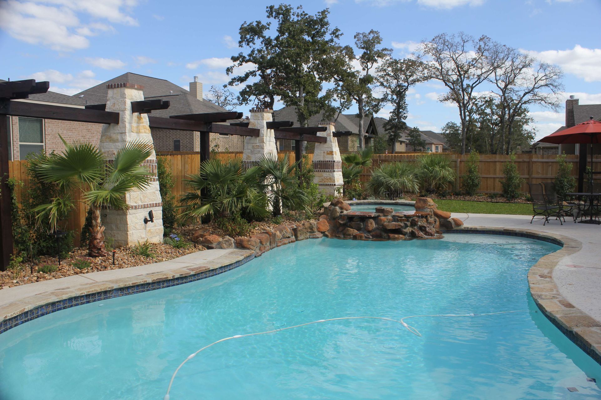 A large swimming pool with a waterfall in the middle of it