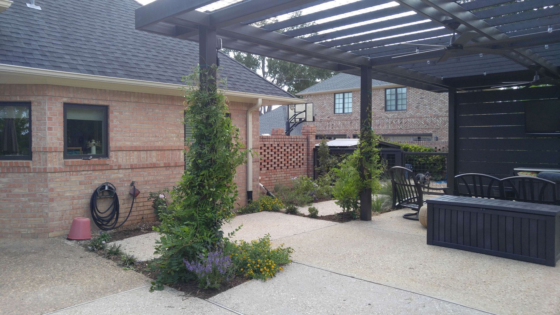 There is a pergola in the backyard of a house.