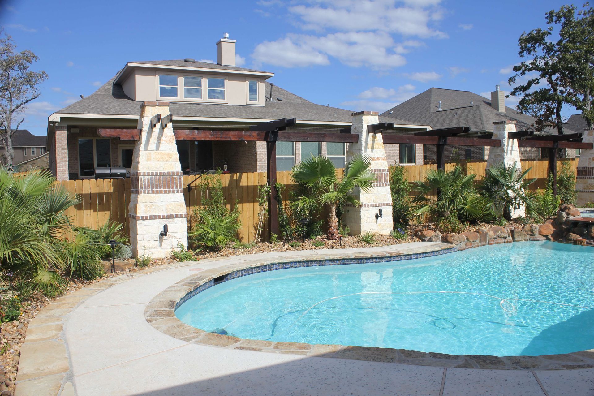 A large house with a swimming pool in front of it