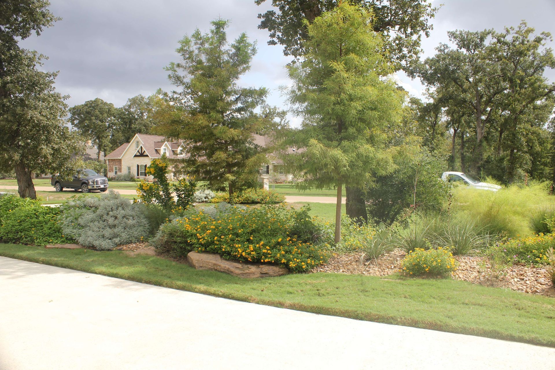 A driveway in a residential area with a house in the background