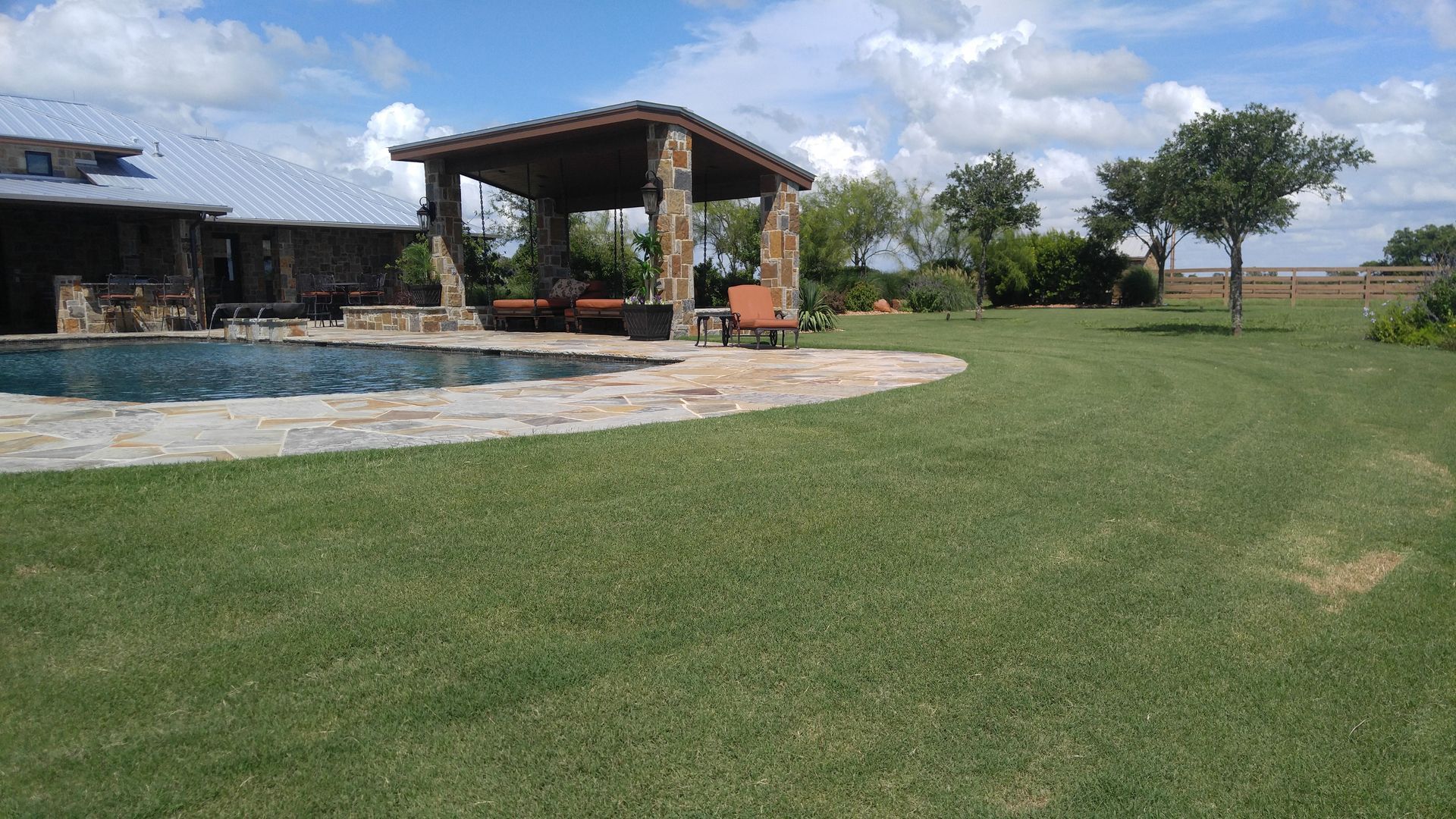 A house with a pool and a gazebo in the backyard.
