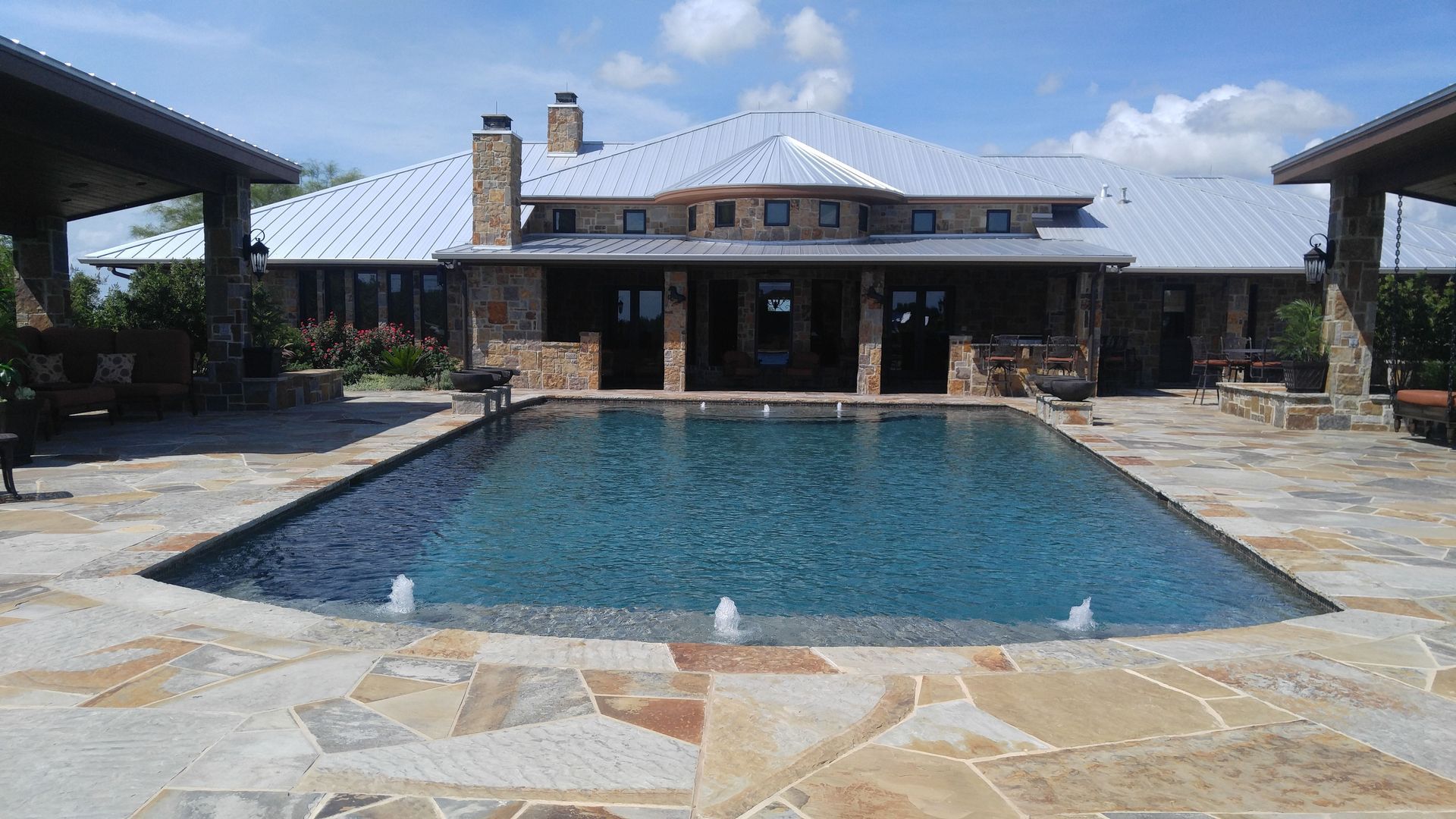 A large house with a large swimming pool in front of it