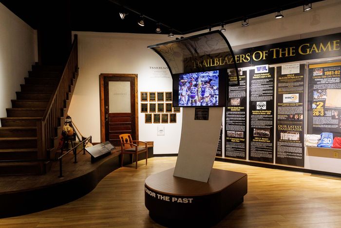Museum exhibit with staircase, chairs, and “Wonders of the Game” display panels