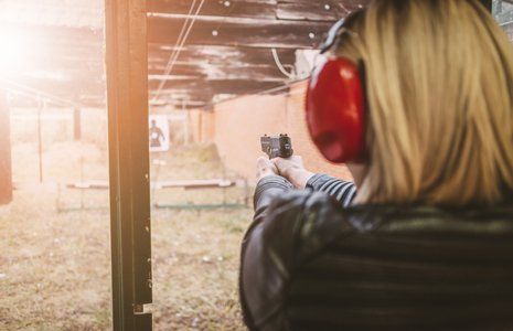 Firearms — Woman Firing Gun On Training Area in Lancaster, CA