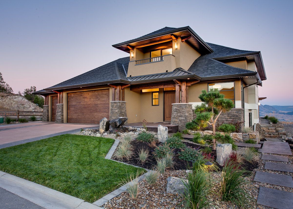 A large house with a lush green lawn in front of it