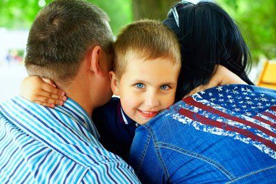 Adoption — Boy Hugging His Mom and Dad in Columbus, GA