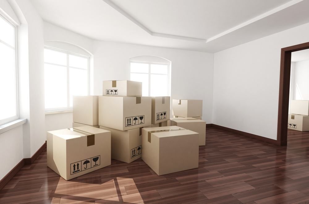 Cardboard Boxes Stacked in a Bright Room — JR Removals Mackay in Sarina, QLD