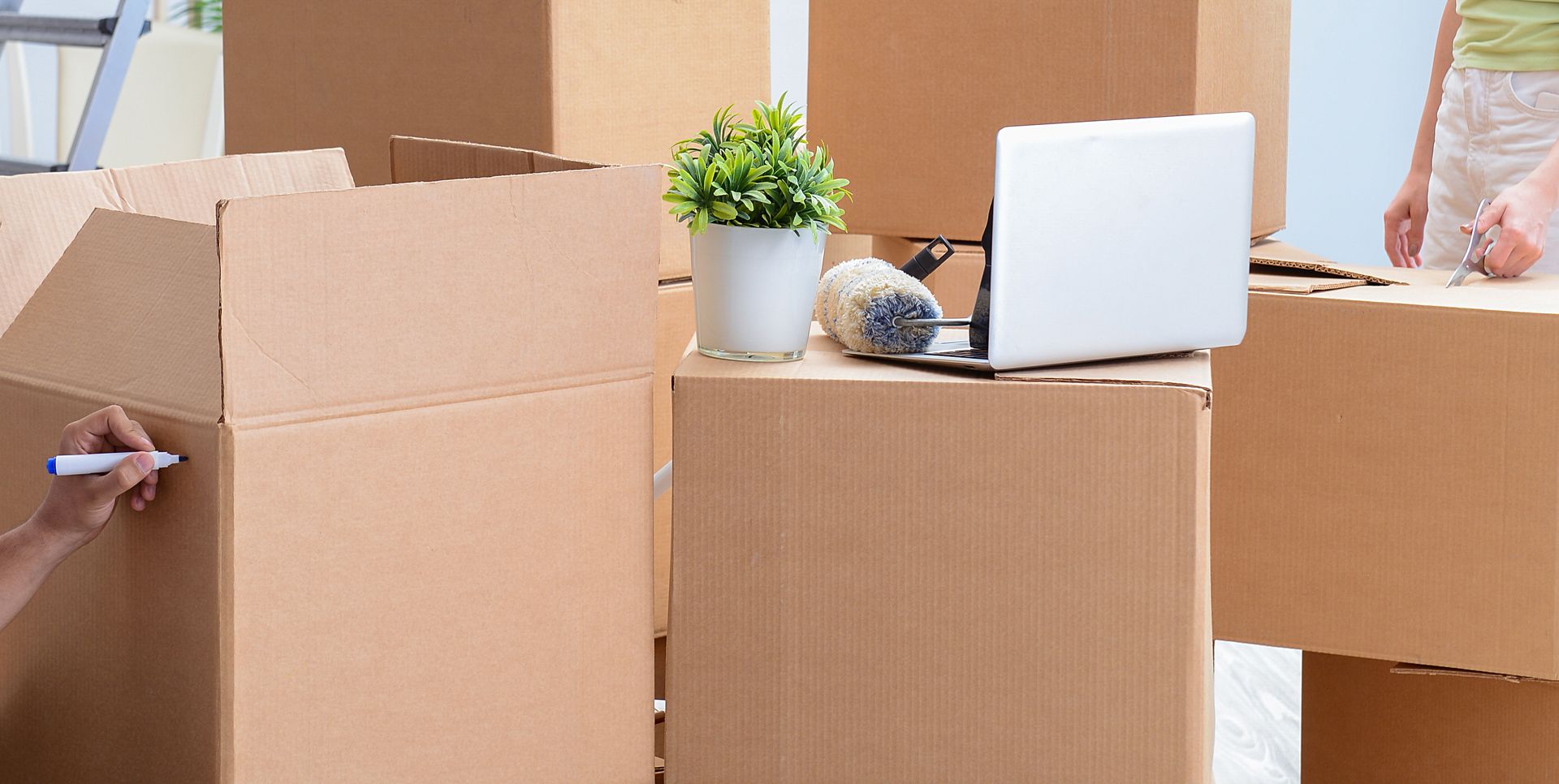 Person Packing Boxes During a Move — JR Removals Mackay in Sarina, QLD