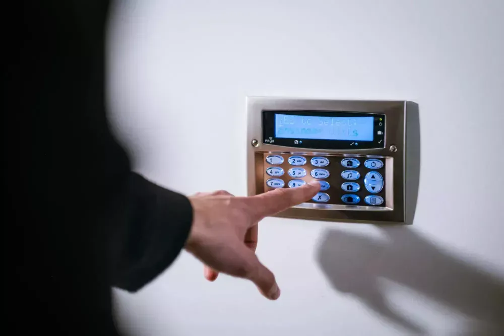 A person is pressing a button on a security system.