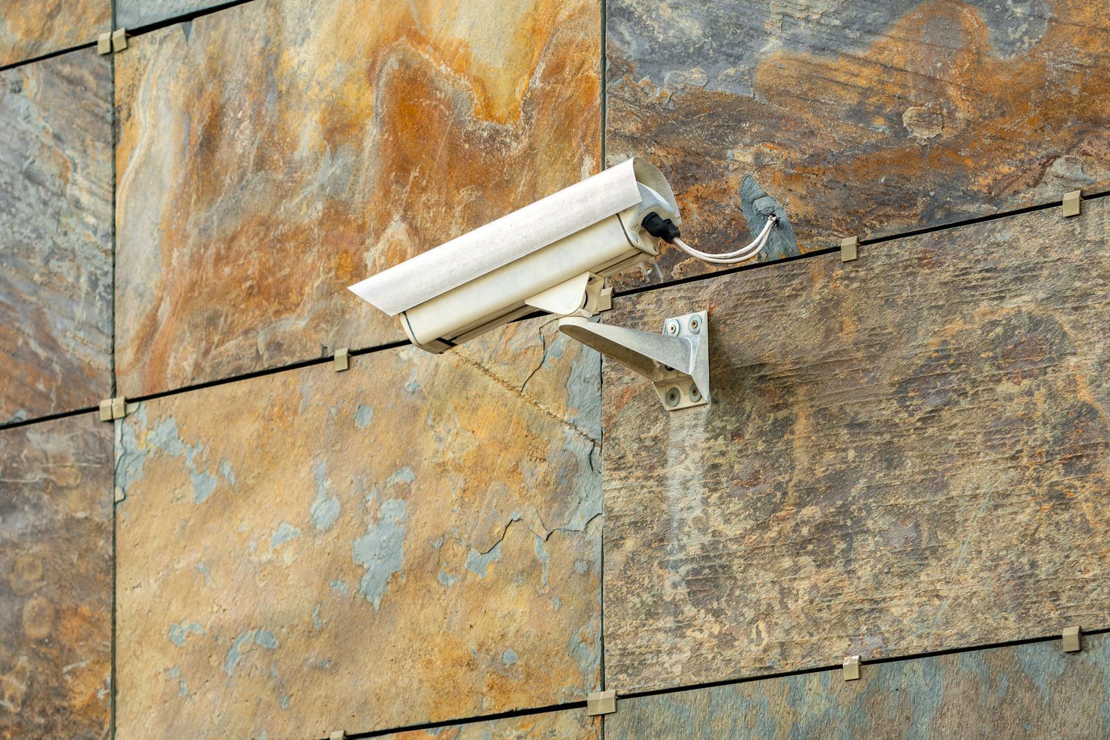 A security camera is mounted on the side of a building.