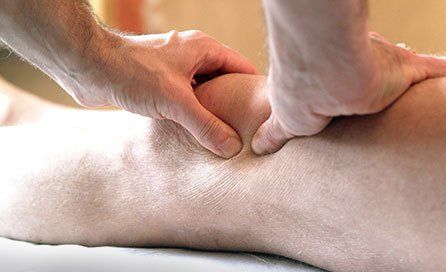 An injured knee being massaged