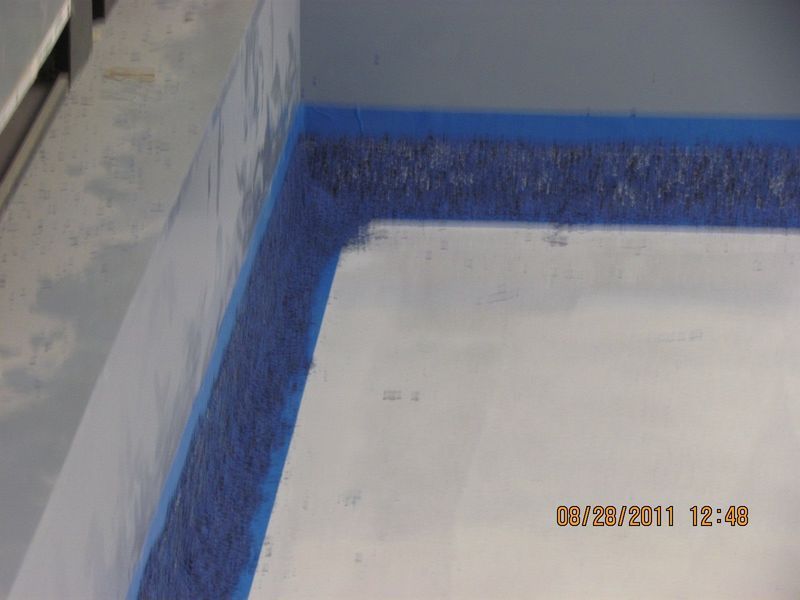 Corner of a room with a blue border, white interior. Date stamp visible in the bottom right corner.