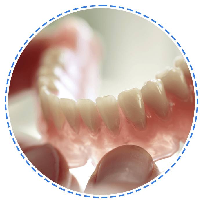 Dental Technician Holding a Denture — Launceston, TAS — Everything Dental Pty Ltd