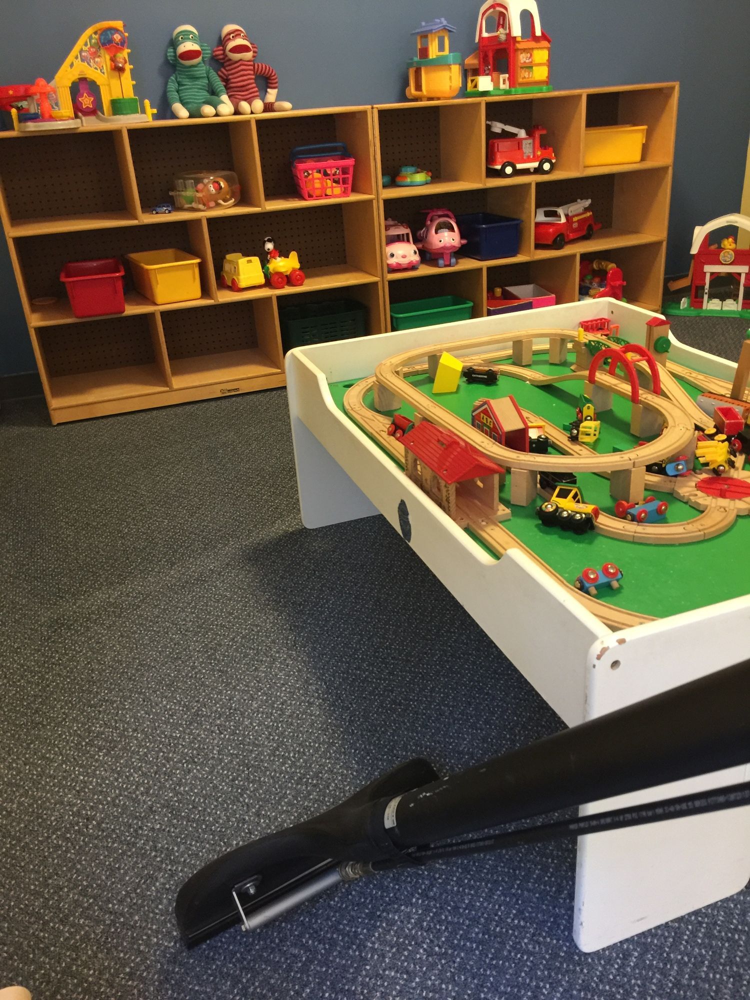 A toy train set is on a table in a room