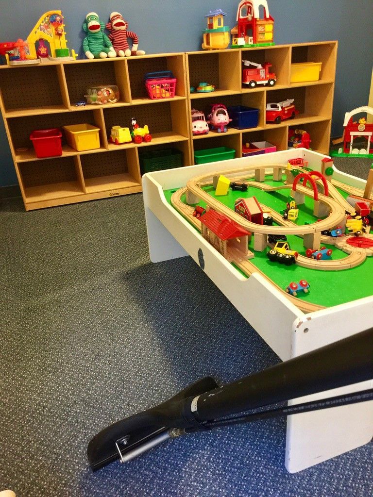 A toy train set is on a table in a room.