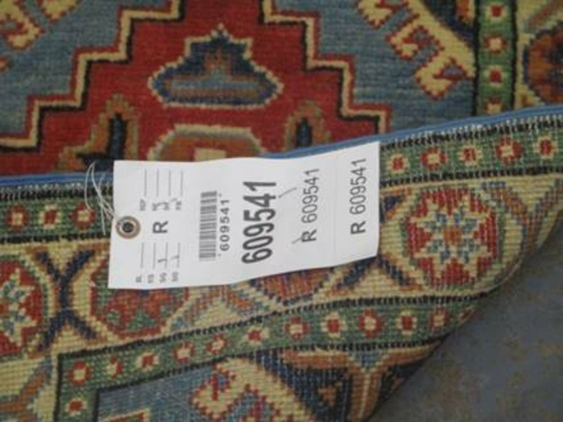 A rug with a tag that says 609541 on it