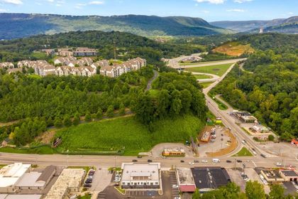 An aerial view of a city with mountains in the background.