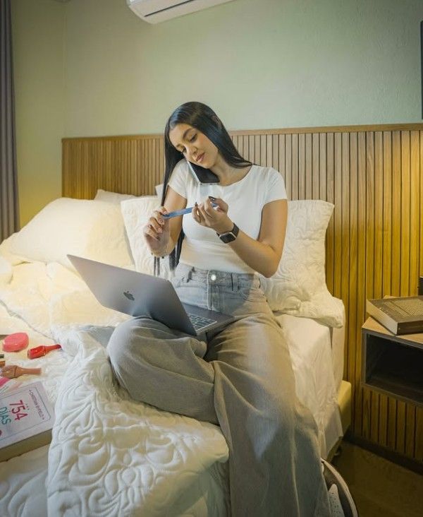A room with a desk and chairs and a mirror on the wall.