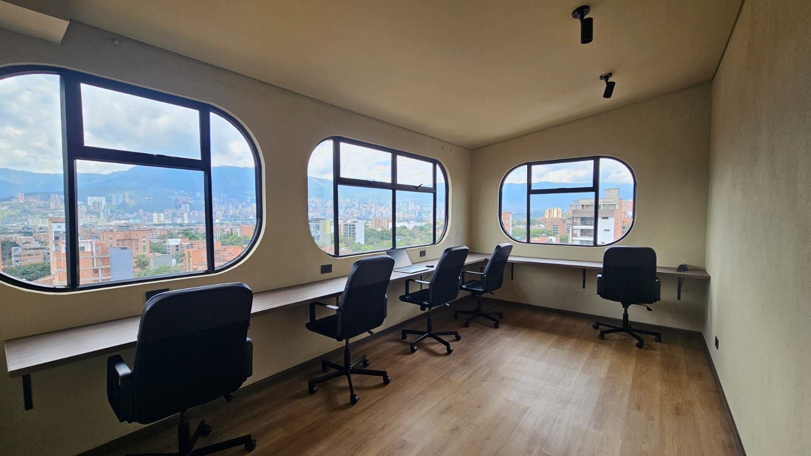 A bedroom with a large bed , desk and chair.