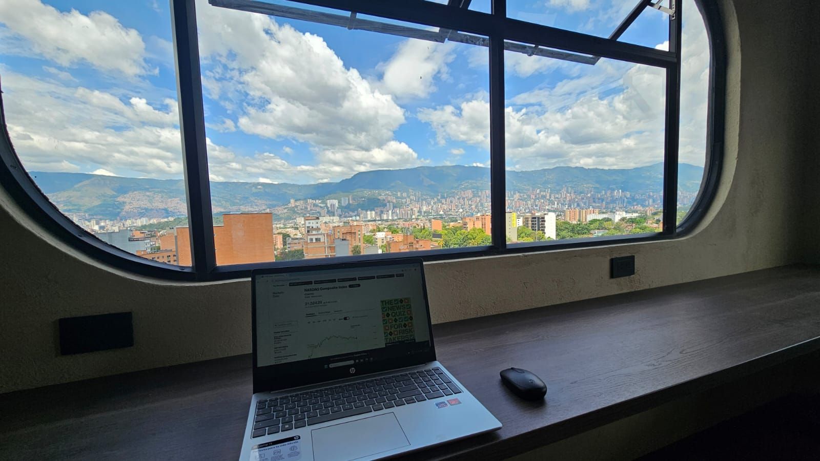 A living room with a couch , chair , and potted plant.