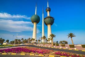Three very tall towers are sitting next to each other on the side of a road.