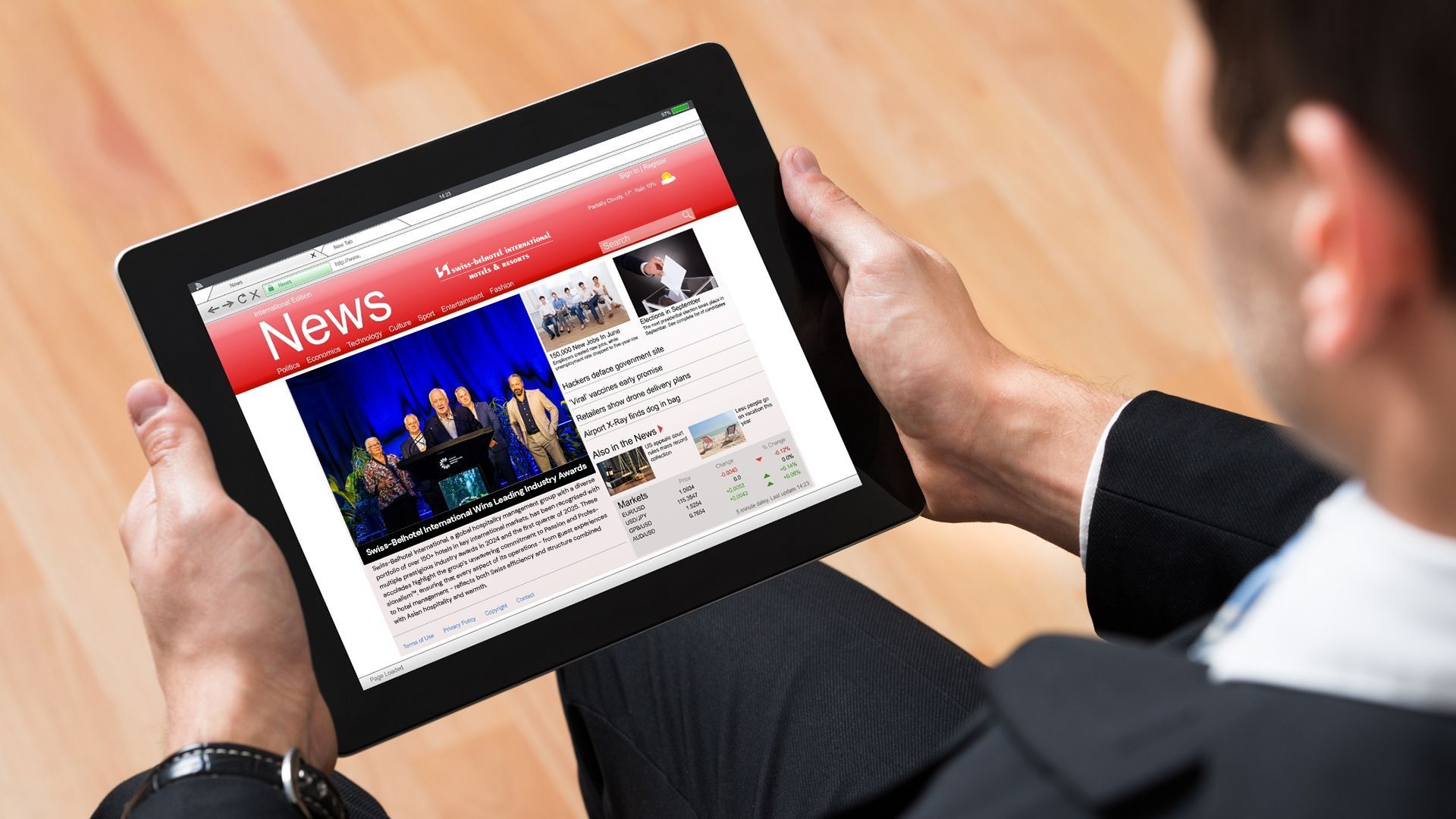 A man and a woman are standing next to each other at a hotel reception desk.